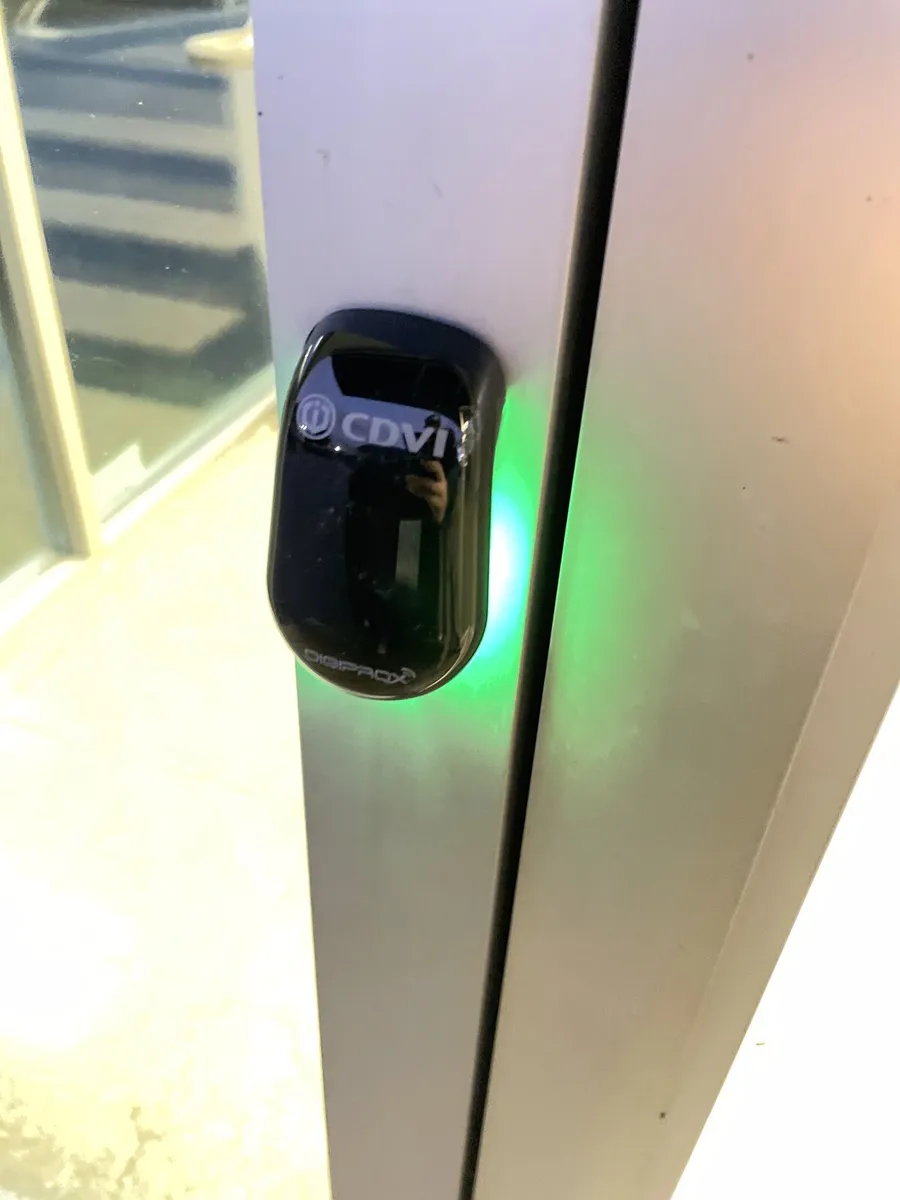 Access card reader installed on a commercial door frame