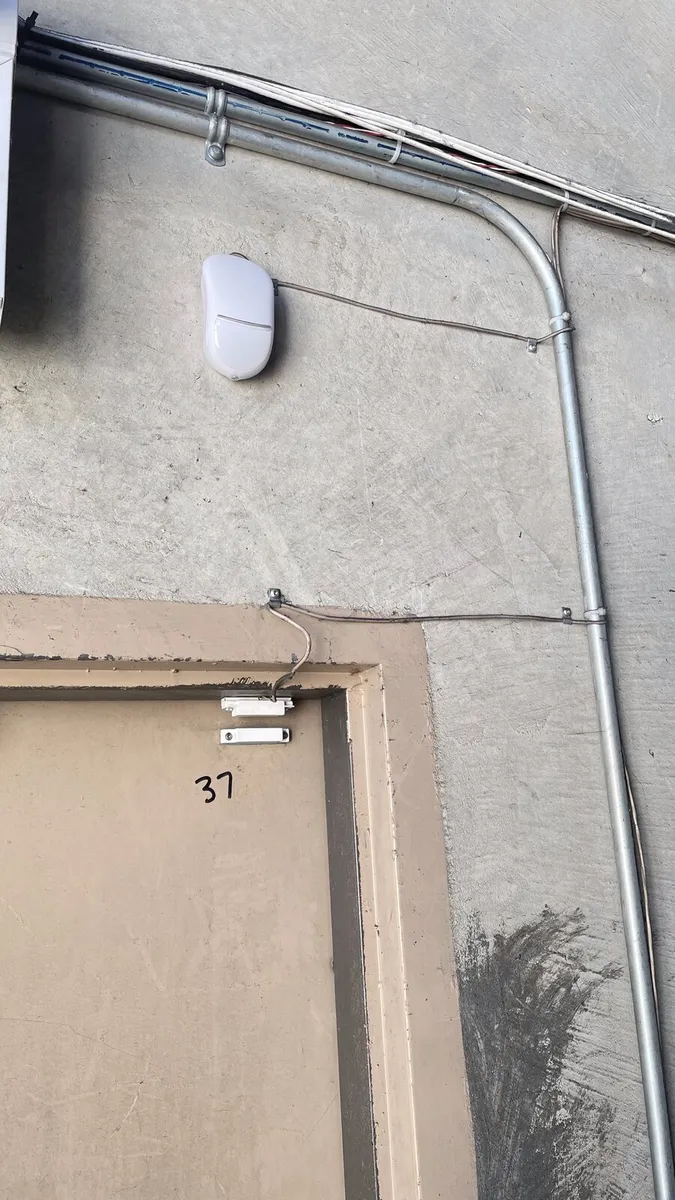 Door contact and motion sensor above a utility room door