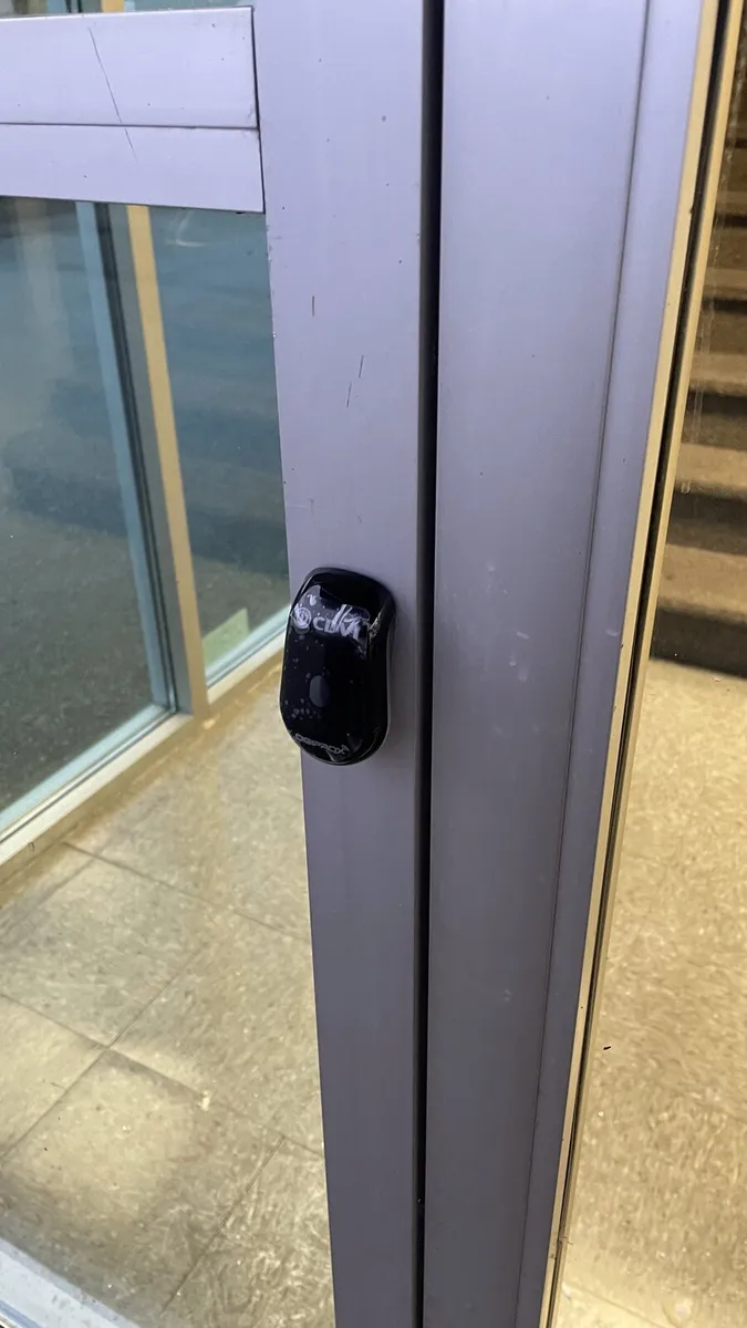 Door hardware with access reader on a commercial entrance
